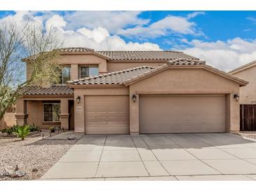 Attractive two-story home featuring a terracotta tile roof and a spacious three-car garage at 3239 E San Manuel Rd, San Tan Valley, AZ 85143