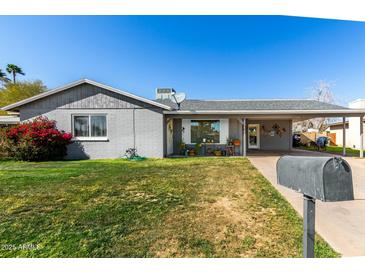 Charming single-story home with well-maintained lawn and covered parking at 3340 W Ironwood Dr, Phoenix, AZ 85051