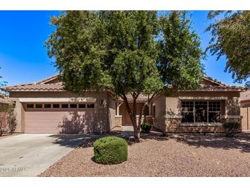Charming single-story home with a desert landscaped yard and mature shade tree at 4086 E County Down Dr, Chandler, AZ 85249