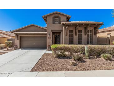 Inviting single-Gathering home with manicured landscaping, a two car garage and decorative front door at 13641 W Jesse Red Dr, Peoria, AZ 85383