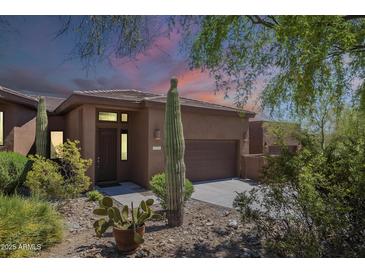 Charming desert home featuring a well-manicured yard with native cacti and a two-car garage at 16248 E Ridgeline Dr, Fountain Hills, AZ 85268