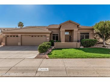 Charming single-story home featuring a three-car garage, well-maintained landscaping, and a neutral-toned exterior at 18036 N 49Th St, Scottsdale, AZ 85254