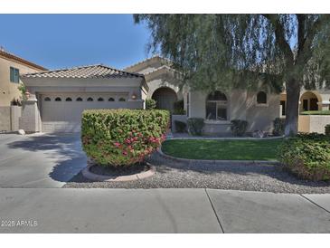 Charming single-story home featuring a well-manicured lawn, mature tree, and a two-car garage at 3631 S Salt Cedar St, Chandler, AZ 85286