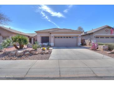 Charming single-story home with desert landscaping and a spacious driveway, creating a welcoming curb appeal at 44161 W Venture Ln, Maricopa, AZ 85139