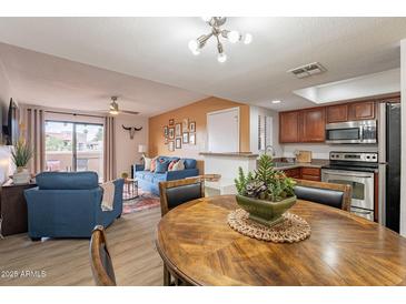 Bright open concept living room and kitchen features lots of natural light and comfortable seating at 5757 W Eugie Ave # 2081, Glendale, AZ 85304