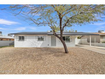 Charming single-story home with a well-maintained exterior and rock landscaping at 7526 E Drummer Ave, Mesa, AZ 85208