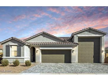 Charming single-story home featuring a three-car garage, neutral color palette and desert landscaping at 786 W Palo Verde W Dr, Casa Grande, AZ 85122