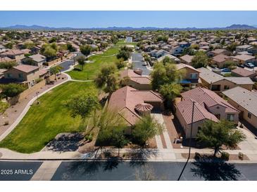 Expansive aerial view of a desert community showcasing lush green spaces and numerous single-Gathering homes at 897 E Cherry Hills Dr, Chandler, AZ 85249