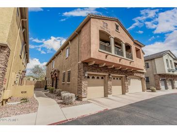 Inviting townhouse featuring a three-car garage, charming stone accents and a private balcony perfect for relaxing outdoors at 1350 S Greenfield Rd # 1225, Mesa, AZ 85206