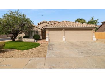 Charming single-story home featuring a well-maintained front yard, neutral exterior, and a spacious two-car garage at 17828 N 50Th St, Scottsdale, AZ 85254