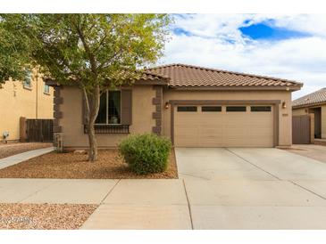 Charming single-story home featuring a two-car garage, desert landscaping, and a tile roof at 21145 E Via De Olivos --, Queen Creek, AZ 85142