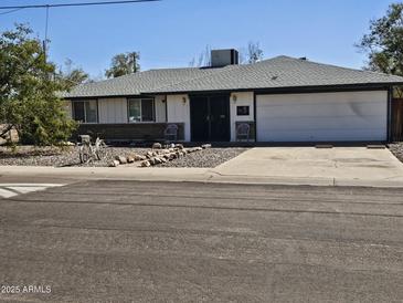 Charming single-story home with a well-manicured front yard and attached garage at 2515 E Mcarthur Dr, Tempe, AZ 85288