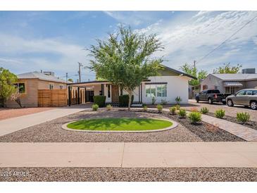 Charming single-story home with a well-manicured front yard and tasteful landscaping at 291 N Washington St, Chandler, AZ 85225