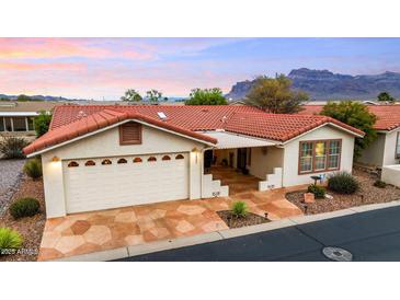 Inviting single-story home with a red tile roof, a two-car garage, and charming desert landscaping at 3301 S Goldfield Rd # 3005, Apache Junction, AZ 85119