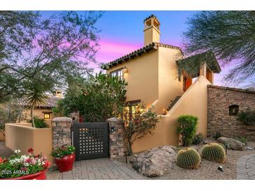 Stunning home showcasing a stucco exterior, well-manicured landscaping, and a welcoming stone pathway at 42171 N Saguaro Forest Dr, Scottsdale, AZ 85262