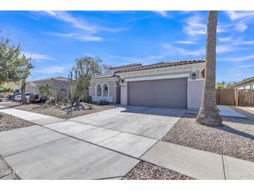 Charming single-story home featuring desert landscaping and a spacious two-car garage at 877 E La Costa Pl, Chandler, AZ 85249