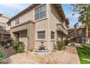 Charming stucco townhome featuring a well-maintained courtyard and decorative fountain at 10017 E Mountain View Road -- # 1045, Scottsdale, AZ 85258