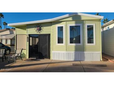 Inviting mobile home with a charming exterior, featuring a cozy porch area at 1284 S Sioux Dr # 1284, Apache Junction, AZ 85119