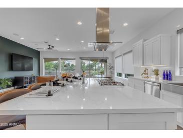 Bright kitchen with a large island and stainless steel range hood and appliances, perfect for cooking and entertaining at 187 E Santa Lucia Ln, Queen Creek, AZ 85140