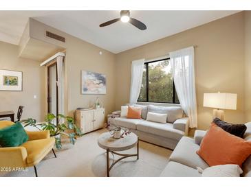 Cozy living room featuring neutral tones, comfortable seating, and a bright window view at 3330 S Gilbert Rd # 2090, Chandler, AZ 85286