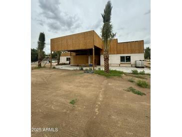 Exterior view of property under construction with palm trees and concrete slab at 5550 E Shea Blvd, Scottsdale, AZ 85254