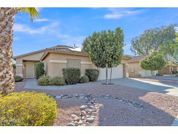 Charming single-story home featuring desert landscaping, a tile roof, and a well-maintained two-car garage at 6071 S Topaz Pl, Chandler, AZ 85249