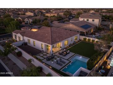 Aerial view showcases the outdoor living spaces of this home, featuring a pool, backyard, and patios at 10511 E Diffraction Ave, Mesa, AZ 85212