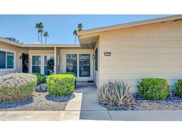 Charming single-story home with desert landscaping and a welcoming walkway to the front door at 17022 N Pinion Ln, Sun City, AZ 85373