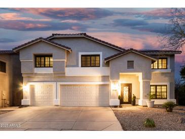 Charming two-story home with a three-car garage and well-manicured landscaping at twilight at 2046 E Avenida Del Sol --, Phoenix, AZ 85024