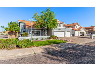 Charming two-story home featuring a well-manicured lawn and a spacious three-car garage at 2218 E Mallard Ct, Gilbert, AZ 85234