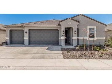 Charming single-Gathering home featuring a three-car garage and a modern architectural design at 2475 W Spaulding Ave, Apache Junction, AZ 85120