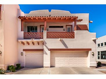 Southwestern-style home featuring a balcony with decorative railing and two-car garage, providing a blend of charm and convenience at 333 N Pennington Dr # 15, Chandler, AZ 85224