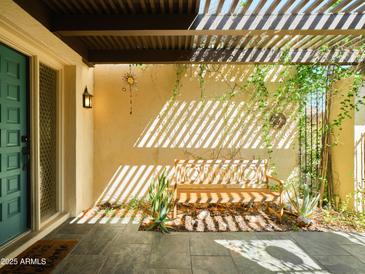 Inviting front porch with bench, pergola and natural light in this beautifully designed home at 37801 N Cave Creek Rd # 11, Cave Creek, AZ 85331