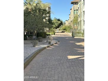 Sidewalk showcasing desert landscaping and the residential building architecture at 5450 E Deer Valley Dr # 2023, Phoenix, AZ 85054