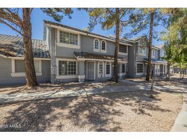 Charming townhome featuring a well-maintained exterior, classic architecture, and inviting curb appeal at 860 N Mcqueen Rd # 1028, Chandler, AZ 85225