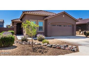 Charming home featuring a well-kept front yard with desert landscaping and a two-car garage at 12351 W Palmaire Ave, Glendale, AZ 85307