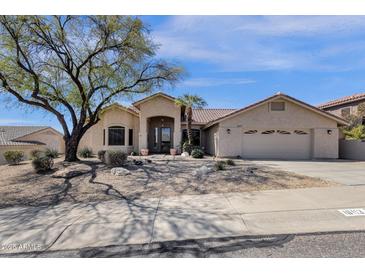 Charming single-story home with desert landscaping, arched entryway, and a spacious two-car garage at 16113 E Andrew Dr, Fountain Hills, AZ 85268