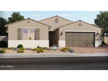 Charming single-story home featuring desert landscaping, a neutral color palette, and an attached two-car garage at 17621 W Pierson St, Goodyear, AZ 85395