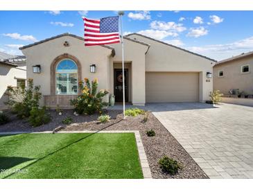 Charming single-Gathering home featuring a neat lawn, garden, and a convenient two-car garage at 21387 W Meadowbrook Ave, Buckeye, AZ 85396