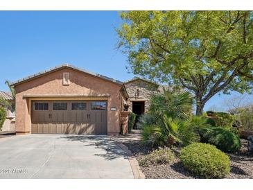 Charming home featuring a well-manicured front yard, a desert landscape, and a two-car garage at 28351 N 130Th Dr, Peoria, AZ 85383