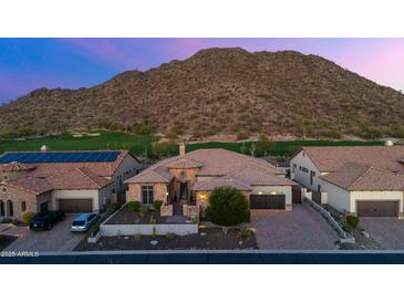 Stunning single-story home featuring desert landscaping, brick driveway and tile roof against a mountain backdrop at 3529 N Boulder Canyon St, Mesa, AZ 85207