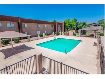 Community pool features a gazebo, shade, and fencing at 3810 N Maryvale Pkwy # 2029, Phoenix, AZ 85031