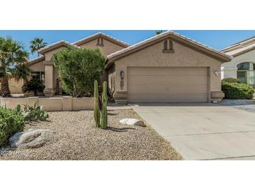 Charming single-story home with a two-car garage, desert landscaping, and well-maintained yard at 4665 E Goldfinch Gate Ln, Phoenix, AZ 85044