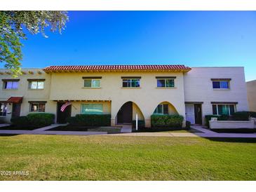 Charming townhome exterior with a red tile roof and well-maintained landscaping at 6961 E Osborn Rd # B, Scottsdale, AZ 85251