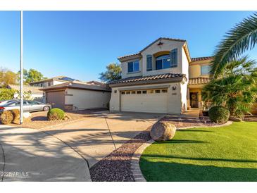 Charming two-story home featuring stucco siding, desert landscaping, and a spacious driveway leading to a two-car garage at 11713 W Tonto St, Avondale, AZ 85323