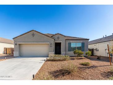 Charming single-story home with a well-maintained front yard and a two-car garage at 30323 W Sheila Ln, Buckeye, AZ 85396