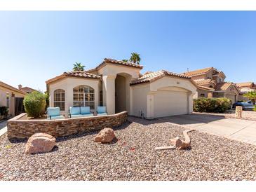 Charming single-story home featuring desert landscaping, a two-car garage, and a cozy seating area at the front of the property at 4779 W Tulsa St, Chandler, AZ 85226