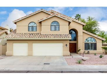 Charming two-story home with a two-car garage, desert landscaping, and a beautiful tile roof at 53 W Pecan Pl, Tempe, AZ 85284