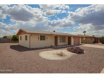 Charming single-story home with desert landscaping under a beautiful blue sky at 5323 E Dodge St, Mesa, AZ 85205