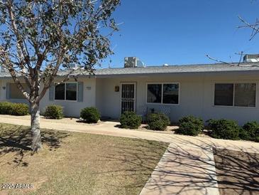 Charming single-story home with well-maintained landscaping and a cozy front entrance at 13807 N Garden Ct Dr, Sun City, AZ 85351